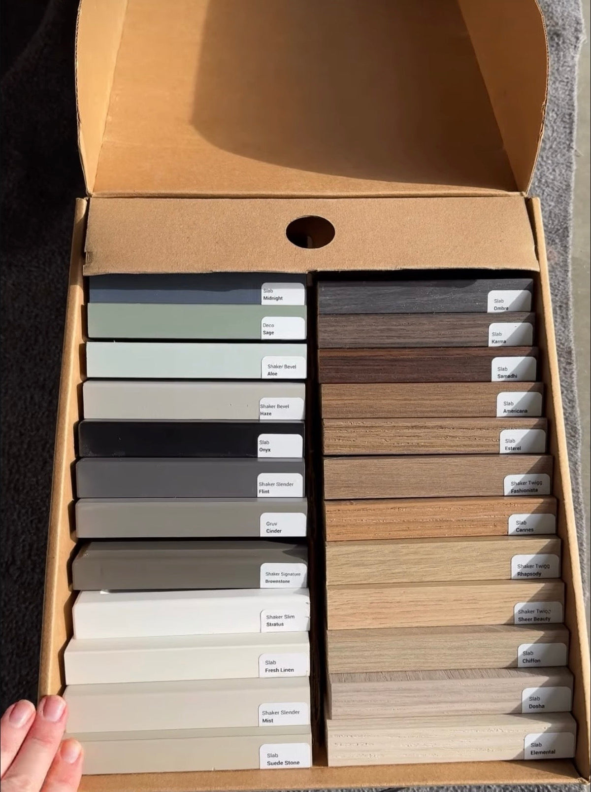 Kitch door sample box open to show painted and woodgrain finishes